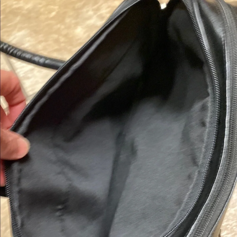 Black Duffel Bag with Structured Design and Smooth Vinyl Practical Utility